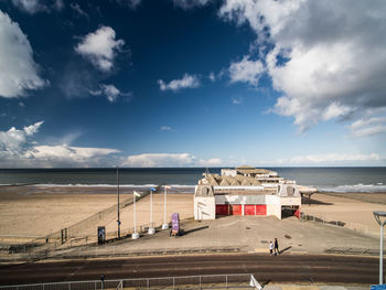 Scenic view of beach against cloudy sky