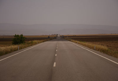 Road against clear sky during sunset