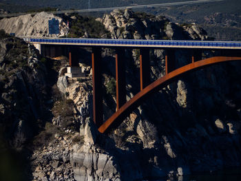 Bridge over stream amidst mountains
