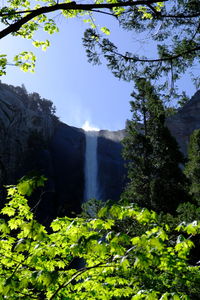 Low angle view of waterfall against sky