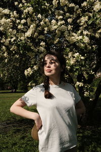 Portrait of woman standing against plants