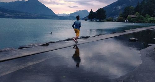 Full length of man standing on lake against sky