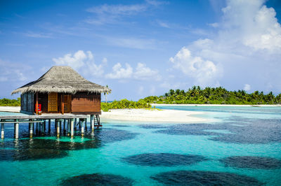 Built structure on sea against blue sky