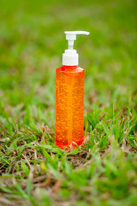 Close-up of bottle on field