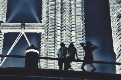 Low angle view of men standing in city