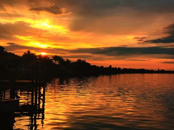 Scenic view of lake against orange sky