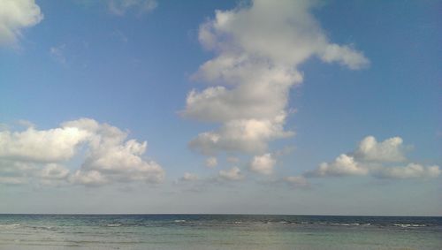 Scenic view of sea against cloudy sky