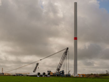 Low angle view of crane against sky