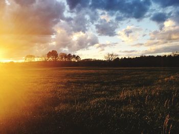 Scenic view of field against dramatic sky