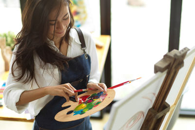 Midsection of woman holding bouquet