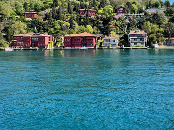 Scenic view of sea and buildings in city