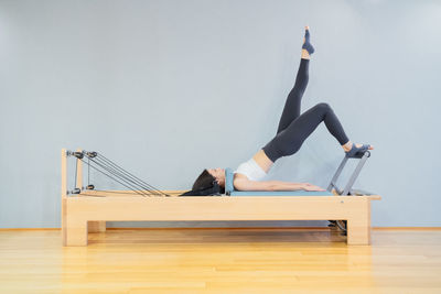 Low angle view of woman exercising in gym