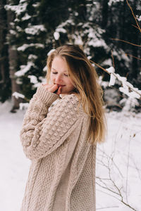 Woman standing on snow covered landscape during winter