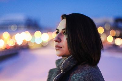 Young woman looking away at night