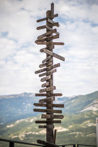 Low angle view of cross against sky