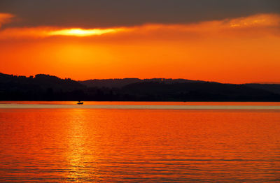 Scenic view of lake against sky during sunset