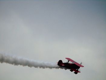 Low angle view of airplane flying in sky