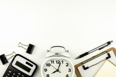 Close-up of clock over white background