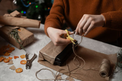 Midsection of man working on table