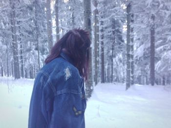 Young woman in snow covered forest