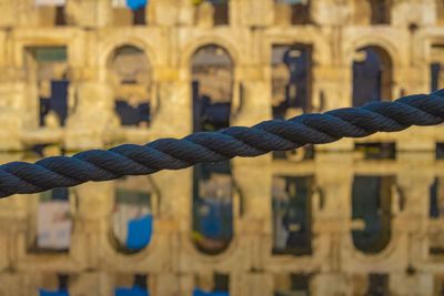 Close-up of ropes on metal fence