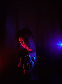 Full length portrait of man holding light painting