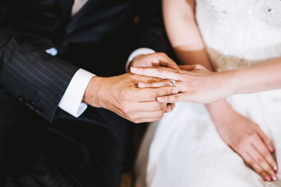 Midsection of couple holding hands