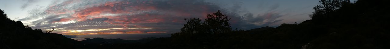 Panoramic view of silhouette mountains against sky at sunset