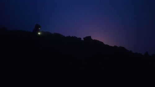 Silhouette of mountain against sky at dusk