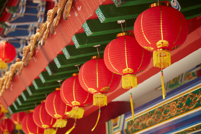 Low angle view of lanterns hanging outside building