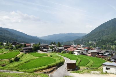 High angle view of houses and mountains against sky