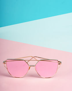 Close-up of sunglasses against swimming pool