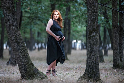 Full length portrait of woman with arms raised