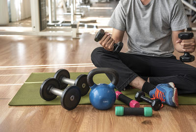 Midsection of man sitting on floor