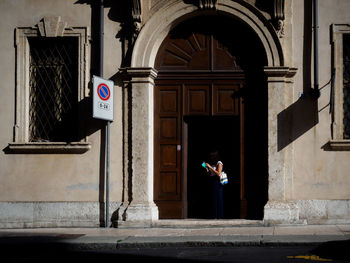 Man standing against built structure