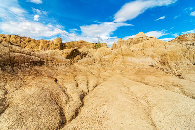 Scenic view of rock formations against cloudy sky at tatacoa desert