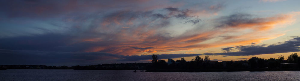 Scenic view of silhouette buildings against sky during sunset