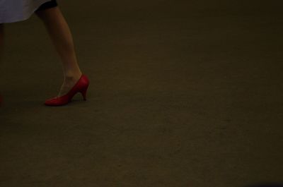 Low section of woman standing on tiled floor