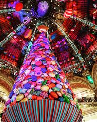 Low angle view of illuminated chandelier hanging on ceiling