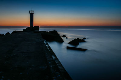 A beautiful long exposure of a breakwater and lighthouse