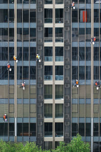 High-rise window washers with scaffold system working on windows of skyscraper