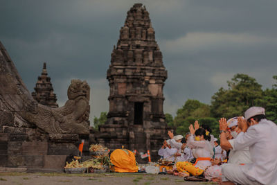 Rear view of people in front of temple