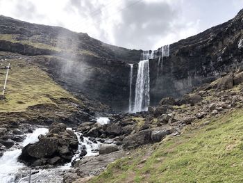 Scenic view of waterfall against sky