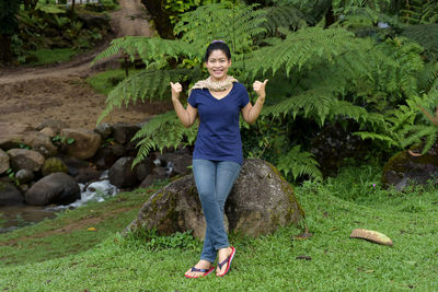 Full length portrait of woman in forest