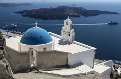 High angle view of building by sea against mountains