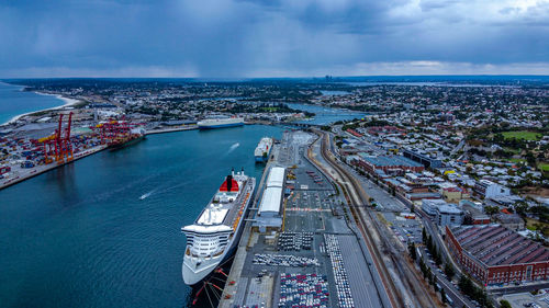 High angle view of city by sea against sky