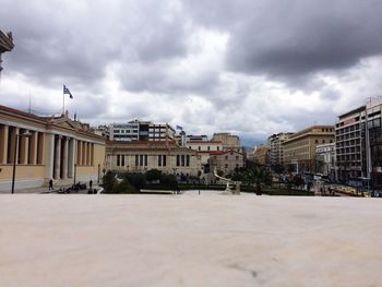 View of buildings in city against cloudy sky