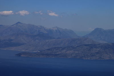 Scenic view of sea and mountains against sky