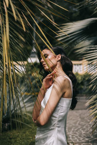 Side view of woman standing on field