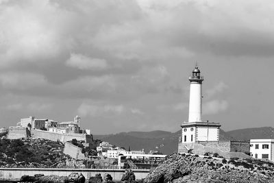 Lighthouse against cloudy sky